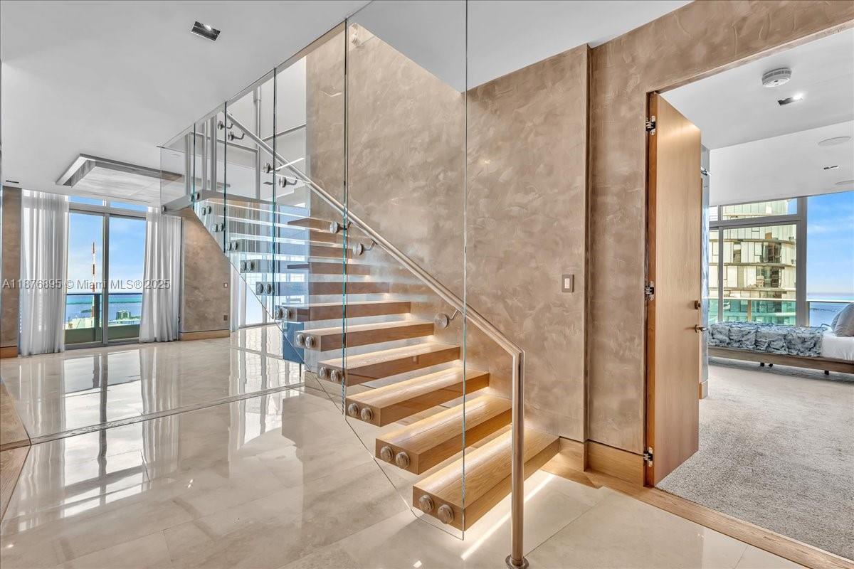 A House In The Sky! This extraordinary 2-Story Penthouse spans over 4300 living sq ft with east facing panoramic views of Biscayne Bay, Atlantic Ocean, & Miami's Skyline. Ideal for indoor & outdoor living with 5 balconies including a rooftop terrace with your very own heated plunge pool. Features include a floating illuminated staircase, open chef’s kitchen with high-end Miele appliances, custom closets/doors, smart home system, & 2 secure storage units. Primary suite w/spa-like marble bath, soaking tub, & oversized shower. The 2nd floor is your ultimate entertainment center that can be converted into a 4th bedroom, in-law suite, you name it. Epic Residences is conveniently located within walking distance from Brickell, Bayfront, & One World Center. This is truly a Gem in the Sky!