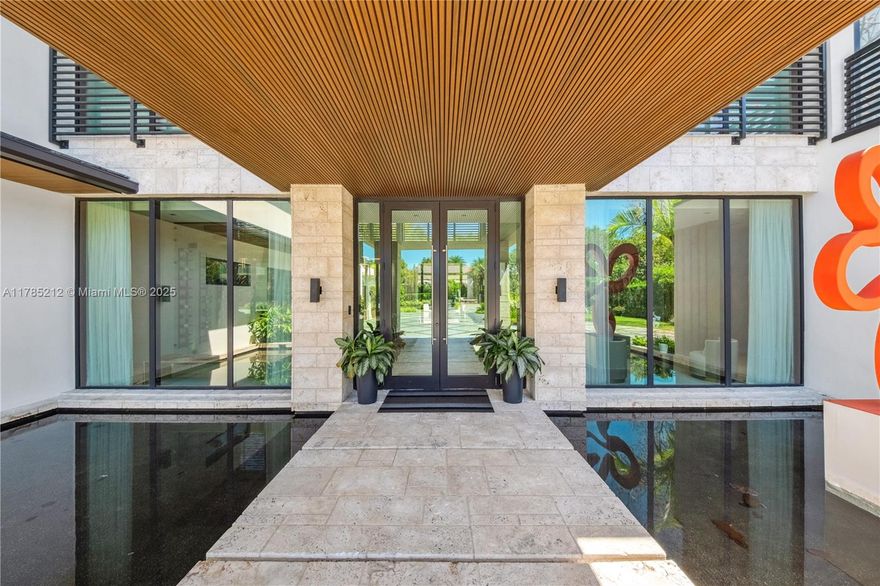 Gated North Pinecrest home sitting on a 50,529 SF lot offering 8 bedrooms, 9.5 bathrooms, a theater, gym, office, 3-car garage & double carport. Grand Coral Stone entrance & dual water features welcomes you in. Blending modern & traditional elements, the home showcases refined elegance throughout. Rich Peruvian teak wood details accentuate the high ceilings, adding warmth & character. The Italkraft kitchen is equipped with top-of-the-line Wolf appliances. All bedroom closets & bathroom vanities are custom-designed by MiaCucina. The home features a full-house generator, glass-enclosed wine display & Control4 automation system. Outdoors include a resort-style pool, summer kitchen & gazebo surrounded by lush landscaping. Just a 4-minute walk to Gulliver Prep—South Miami’s top private school.