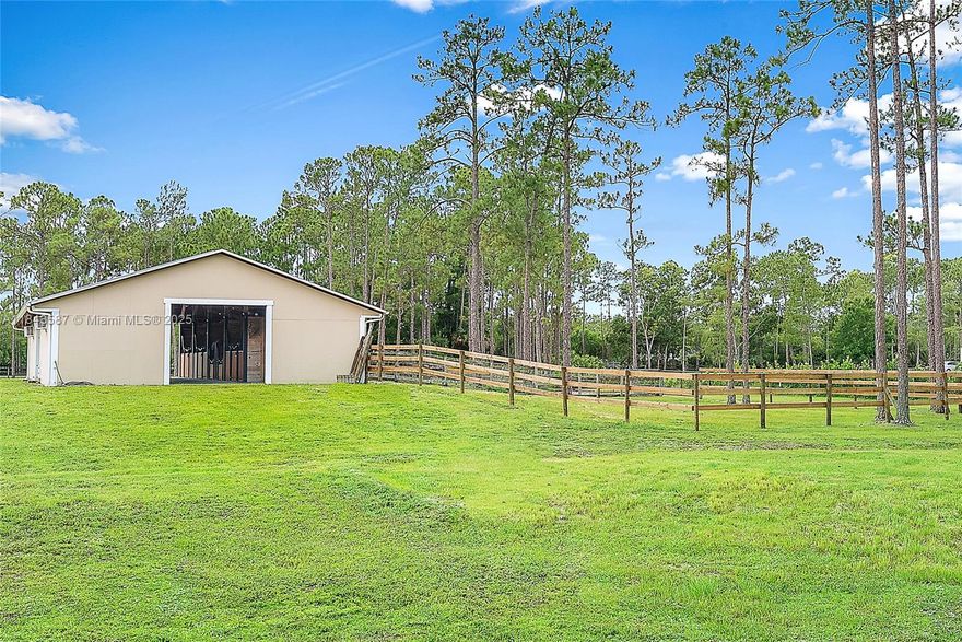 An incredible value in the sought-after Palm Beach Gardens equestrian community of Caloosa, this CBS-built home offers nearly 3,000 sq ft under air, a 2022 metal roof, and a 2018-built 2,000+ sq ft center-aisle barn. The 5-acre fully fenced property provides ample space to add an arena and additional paddocks, making it a versatile choice for equestrian use. The home features a split floor plan, a 702 sq ft garage, and both front and back screened porches. The 2018-barn includes 5 stalls, climate-controlled feed and tack rooms, and multiple turnouts and paddocks. Caloosa community amenities include miles of riding trails, a 32-acre horse park, pickleball courts, playground, and picnic areas, all with low HOA dues. Conveniently located minutes from shopping, dining, and top-rated schools.