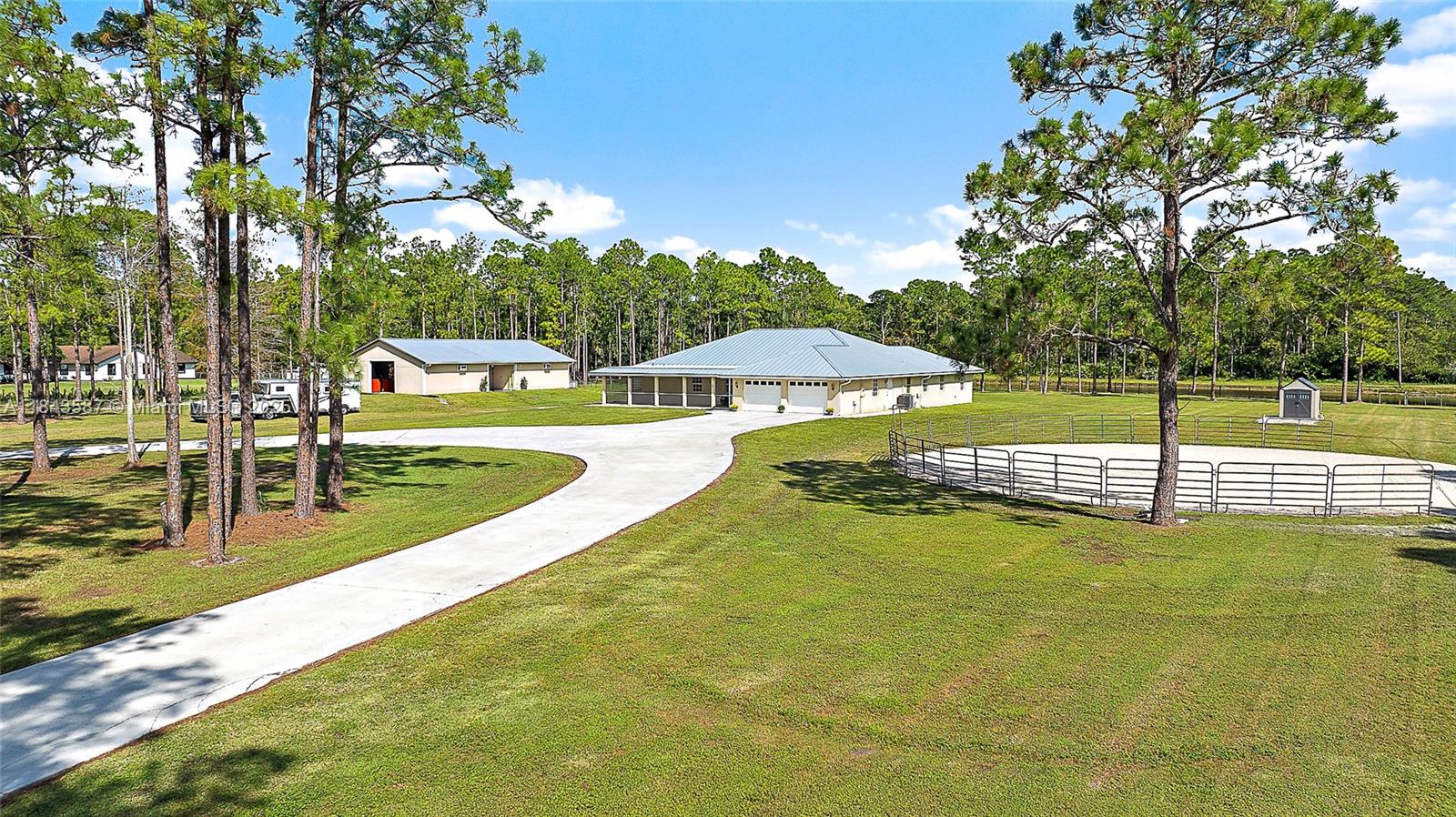 An incredible value in the sought-after Palm Beach Gardens equestrian community of Caloosa, this solid CBS (concrete block) home, featuring a 2022 metal roof and a 2018-built 2,000+ sq ft barn, offers one of the best values in the area. Set on 5 fully fenced acres with private gates, this property provides an ideal combination of quality, functionality, and peace of mind. The one-story home features a split floor plan, generous 702 sqft garage, and both front and back screened porches, providing a comfortable and move-in ready living space. The 2018-built center-aisle barn is a true standout, with 5 stalls, climate-controlled feed and tack rooms, and multiple turnouts and paddocks. Additional equestrian amenities include a round pen, ample space to add an arena or more pastures, and an