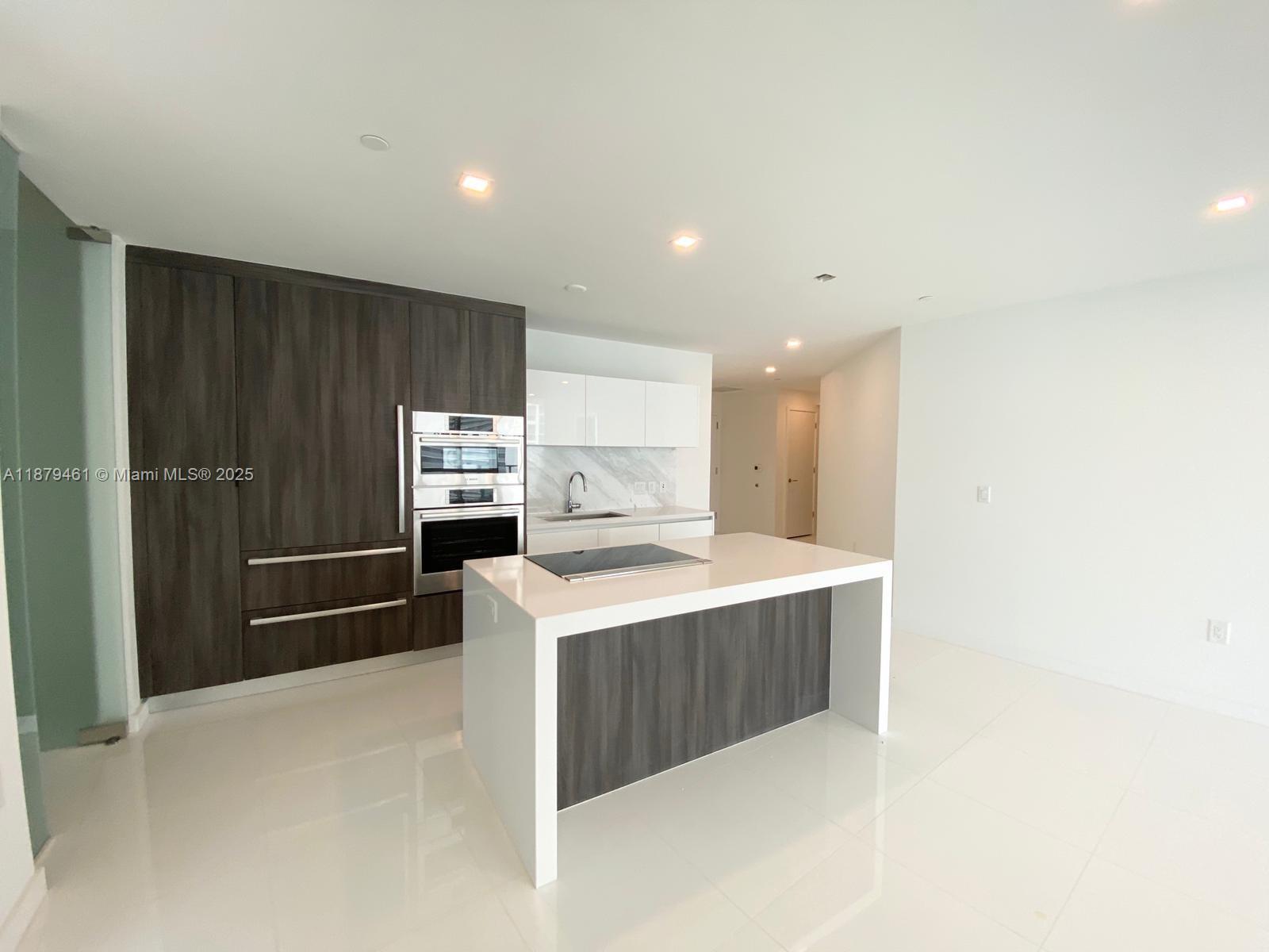 Welcome to your dream residence! This spacious and thoughtfully designed unit features first-floor entry for easy access and offers a smart layout with split bedrooms for added privacy. Spacious first-floor entry unit with split-bedroom layout, walk-in closets, and modern closet cabinetry. Features a stylish cooking island and fully equipped kitchen with stainless steel appliances, wall oven, and washer/dryer. Enjoy high-impact doors and an open balcony. Secure building with guard gate, attended lobby, key/card entry, and secured parking. Amenities include pool, gym, spa/hot tub, sauna, basketball, kids’ play area, and pool table. Resort-style living in a prime location!