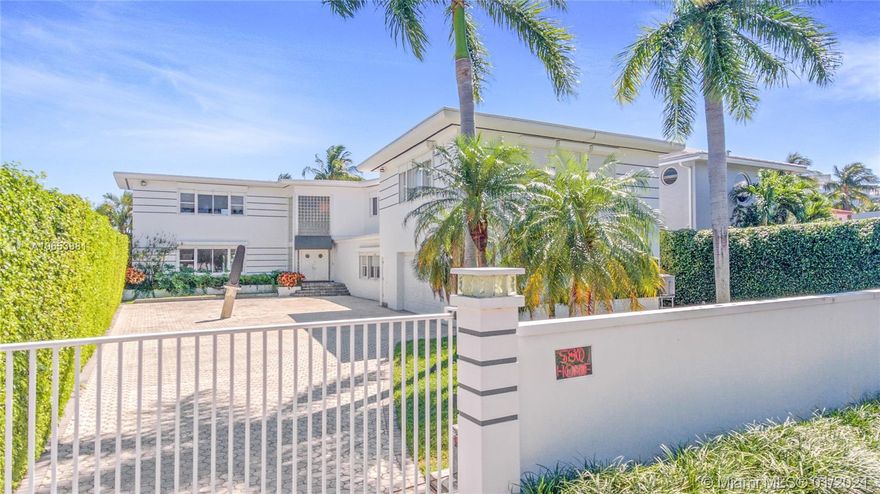 Large waterfront art-deco style home in Miami Beach. Spacious 7 bdrm 7 bath built in 1948 by Norman Giller. Includes studio guesthouse with separate entrance and personal kitchen atop a 2-car garage with extra storage space. Located on quiet Lakeview Drive, just steps from the park and minutes from South Beach. 75 ft of waterfront footage.