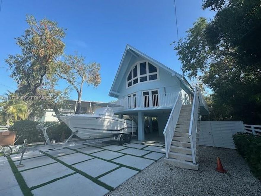 Welcome to your dream retreat in Key Largo! This stunning 4-bedroom, 3-bath home has been fully updated with state-of-the-art features and designer touches throughout. Enjoy luxurious marble flooring, a sleek open-concept layout, and a beautifully remodeled kitchen and baths—including a spa-inspired rain shower for a true touch of indulgence. Impact windows and a durable metal roof provide safety and peace of mind. Outside, a brand-new carport and driveway add both style and convenience. This home is the perfect blend of modern comfort and coastal living in one of the Keys’ most sought-after neighborhoods.