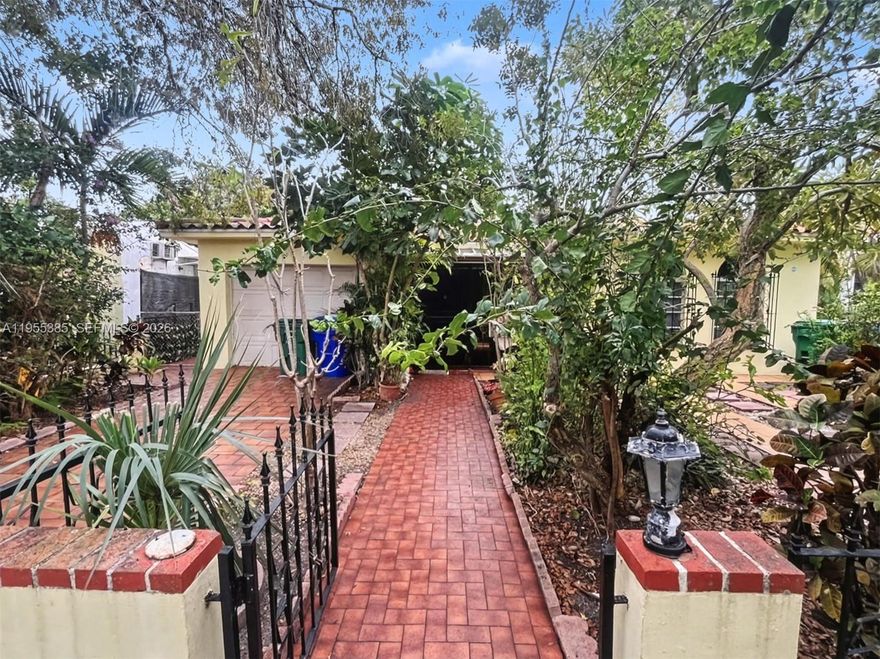 Spacious 5-bedroom, 3-bath residence in historic Shenandoah Neighborhood has the perfect blend of "Old Miami" charm and modern versatility. Situated on a prime 5,900 sq ft. lot, the property features a flexible layout suitable for large families (Adjusted Area: 2712 sq ft). The main living area (3BD/2BA) is bright and inviting, complemented by a separate rear quarter (2BD/1BA) with its own entrance—suitable for an in-law suite.  Enjoy the gated front porch, lush gardens, and mature trees. Key features include a private 1-car garage, two separate parking spaces, and a Florida room.  Location is everything: Steps away from the vibrant culture of Calle Ocho and just minutes from Brickell, Coconut Grove, Coral Gables, Key Biscayne, and the Miami International Airport. Don't miss out!