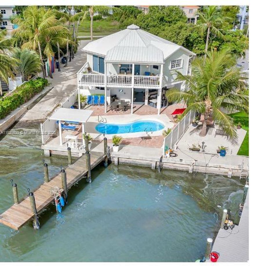 Welcome to your tropical paradise dream island escape in the FL Keys, located in the heart of Marathon! Wake up each day to post card worthy ocean views right from your deck. Step outside and boat directly through the channel with direct ocean access nearby. Boat ramp is included! Property is a short walk to Sombrero Beach, and within easy strolls to local shops & restaurants in central Marathon. The property offers an expansive corner lot with plenty of room for an RV! This home is a dream for savvy investors, boating enthusiasts, or anyone seeking a turnkey Florida Keys cruise & chill residence. his property is rented as a vacation rental and booked consistently throughout the year.  Boat ramp is shared with 2 other persons. HOA is for easement administration only - no HOA dues are paid.