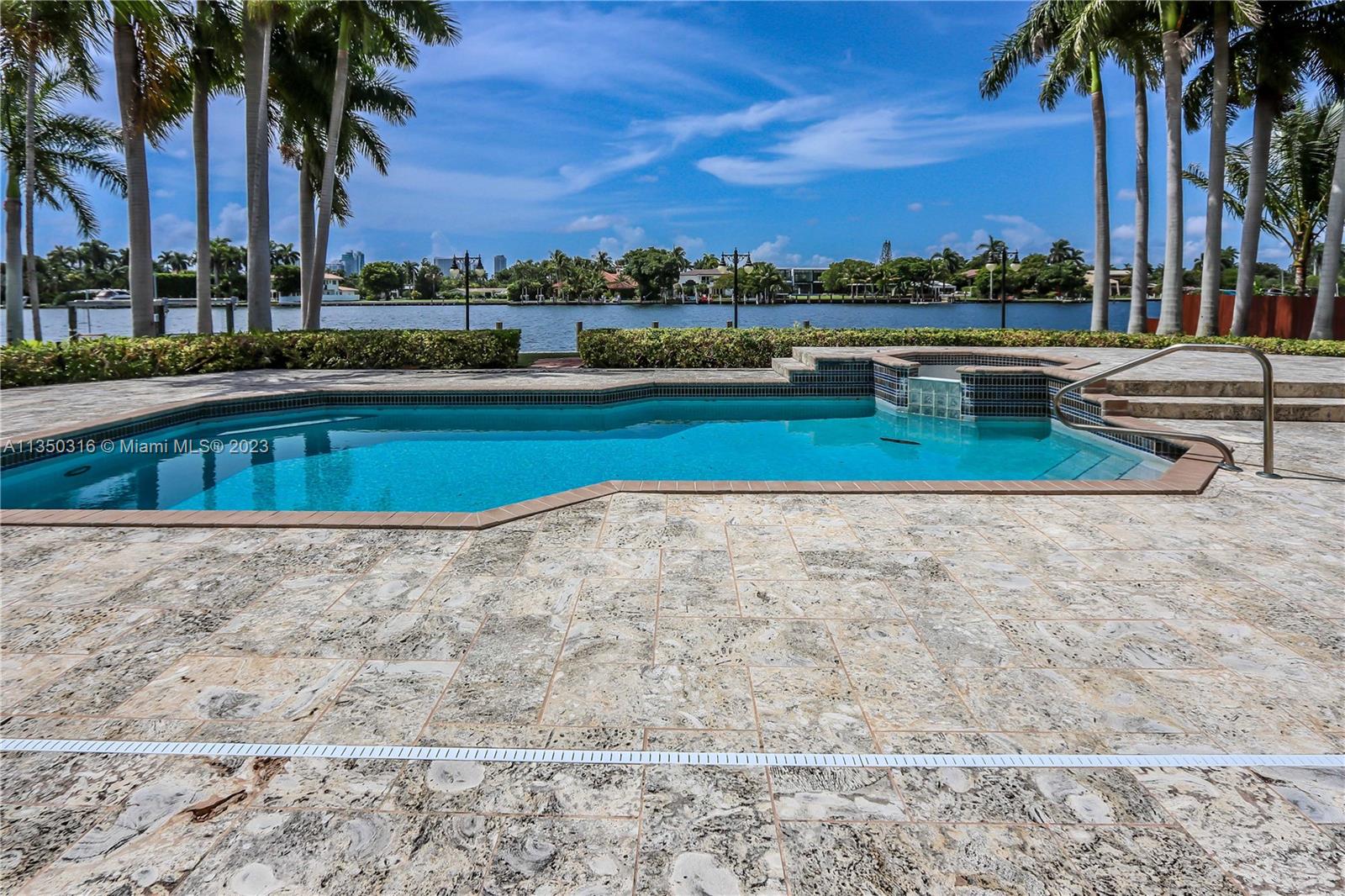 OCEAN ACCESS - NO FIXED BRIDGES! OVER HALF ACRE LOT! INCREDIBLE WATERFRONT PROPERTY! THIS STUNNING 5 BED, 3 FULL BATH, 2 HALF BATH, 2 CAR GARAGE W/ HEATED POOL & JACUZZI WILL BE LOVED BY EVEN THE PICKIEST BUYERS! THIS SPLIT FLOOR PLAN HOME FEATURES A GRANDIOSE DOUBLE DOOR ENTRANCE, VAULTED CEILINGS & CUSTOM MARBLE FLOORS THROUGHOUT. ADDITIONAL FEATURES INCLUDE A DECORATIVE FIREPLACE W/ A MANTLE IMPORTED FROM EUROPE, CUSTOM DOOR HARDWARE, CUSTOM HUNTER-DOUGLAS SHADES THROUGHOUT, OPEN CONCEPT KITCHEN WITH COOKING ISLAND AND PANTRY. THE IMPRESSIVE PRIMARY SUITE OFFERS A SITTING AREA, DUAL SINKS, TUB AND SEPARATE SHOWER. SITUATED ON OVER A HALF ACRE LOT, THE SPACIOUS BACKYARD FEATURES A PRIVATE DOCK WITH APPROX. 100 FT WATER FRONTAGE, OCEAN ACCESS AND NO FIXED BRIDGES - A BOATER OWNER’S DREAM!