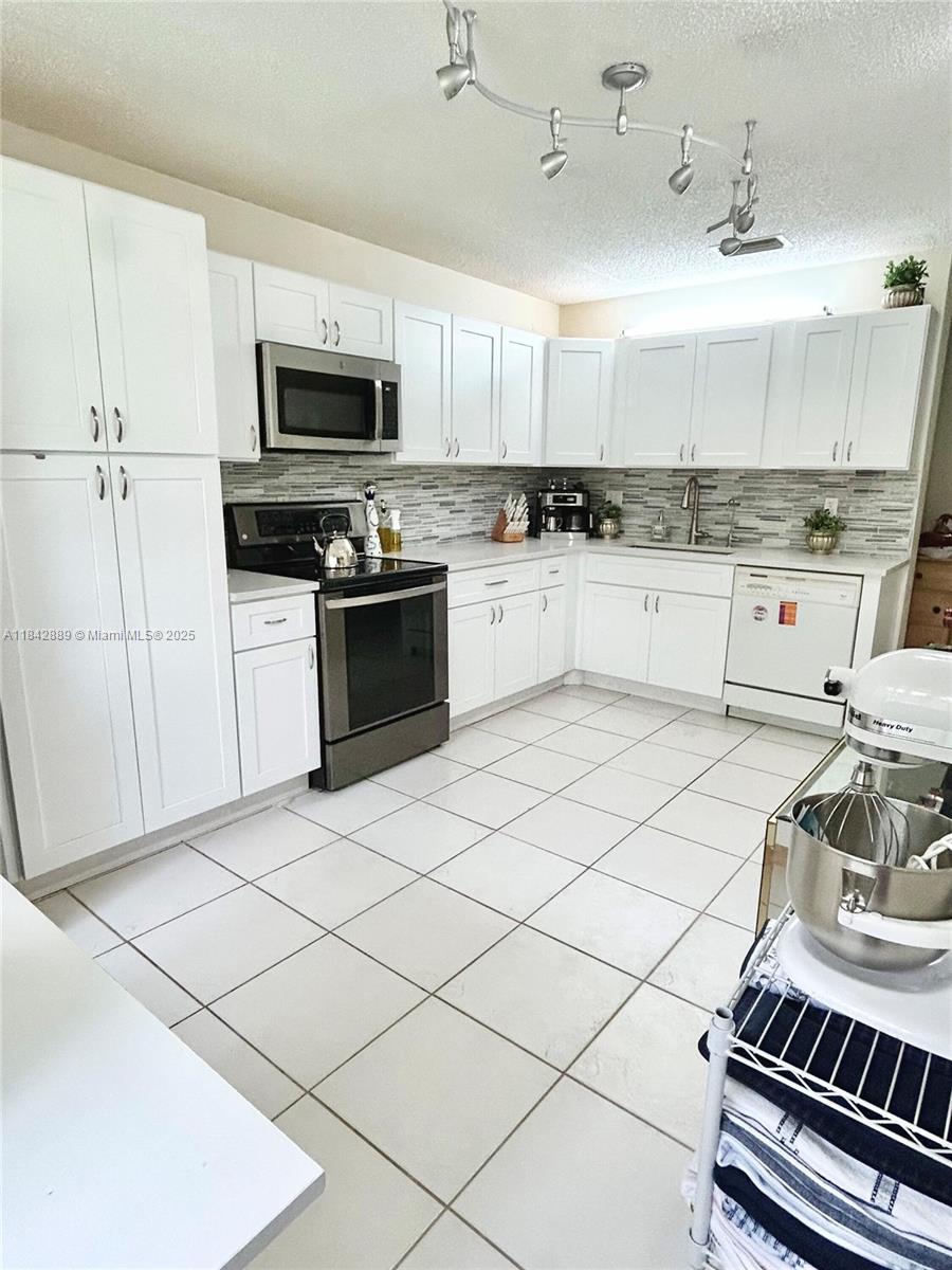 SPACIOUS & Charming Condo! This beautifully renovated 3/2 unit is 1792 SF! On 2nd floor, providing beautiful pool & landscape views. Features spacious living area with abundant natural light. Bathrooms are completely redone: porcelain tile, new vanities, showers, toilets & glass doors. LARGE New Kitchen with beautiful cabinets & spacious sparkling quartz countertops, backsplash, sink & faucet. Ample cabinet space, & still more room to add additional cabinetry if desired. LARGE Master Bedroom with Walk in closet. LARGE 2nd Bedroom overlooking pool. 3rd Bedroom can be used as an office to accommodate your work from home lifestyle. Vaulted Ceilings. Full-size laundry room with Washer/Dryer inside. All ages welcome. Ask about additional options.