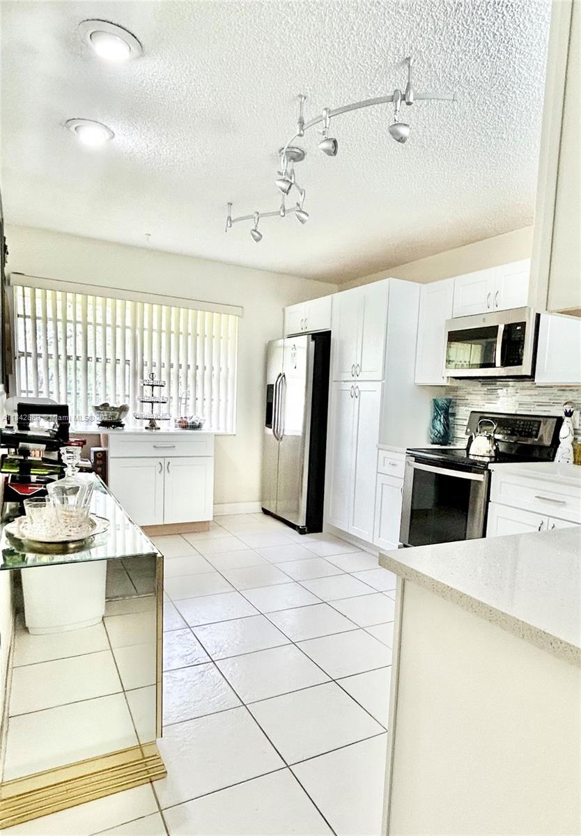 SPACIOUS & Charming Condo! This beautifully renovated 3/2 unit is 1792 SF! On 2nd floor, providing beautiful pool & landscape views. Features spacious living area with abundant natural light. Bathrooms are completely redone: porcelain tile, new vanities, showers, toilets & glass doors. LARGE New Kitchen with beautiful cabinets & spacious sparkling quartz countertops, backsplash, sink & faucet. Ample cabinet space, & still more room to add additional cabinetry if desired. LARGE Master Bedroom with Walk in closet. LARGE 2nd Bedroom overlooking pool. 3rd Bedroom can be used as an office to accommodate your work from home lifestyle. Vaulted Ceilings. Full-size laundry room with Washer/Dryer inside. All ages welcome. Ask about additional options.