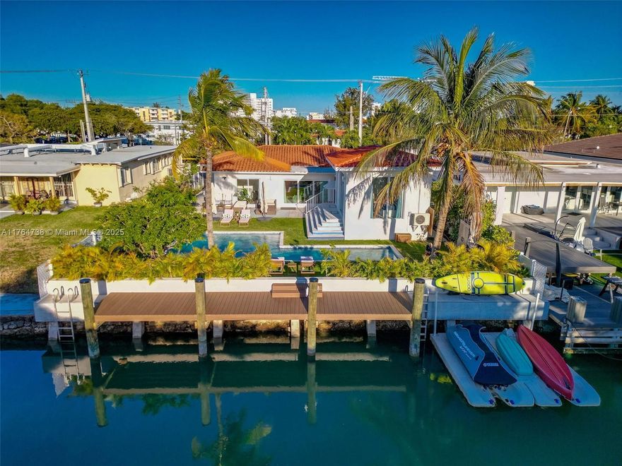 BOATERS DREAM ! NO FIXED BRIDGES Discover a spectacular upgraded 4-bedroom,3-bath home offering luxurious living in the Biscayne Point community. Enjoy 60 feet of water frontage,no fixed bridges,and a stunning backyard retreat ready for your waterfront lifestyle. This bright and airy home features an updated kitchen,a spacious family room&impact windows throughout.A newly built cabana offers the perfect space for guests or a private office.Step outside to an expansive backyard oasis w. a heated saltwater pool featuring a 37-ft lap lane,outdoor hot-water shower,brand-new seawall,& a private dock. Add. highlights include a one-car garage,EV charging & a gated entry W. dual motorized gates.Less than a mile to the beach,restaurants,parks.Total structure :2654 SF ( house + cabana )on 9000sf lot