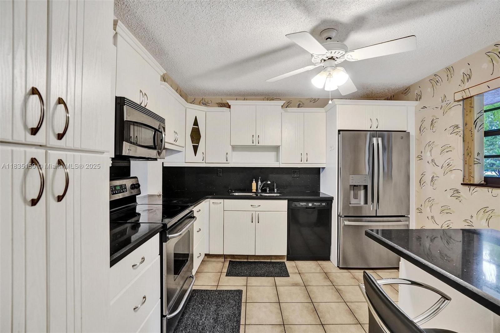 Excellent opportunity to own a newly remodeled 2 BD | 2 BA unit in a quiet 55+ community. This handyman special features concrete floors, stylish wallpaper accents, and is perfect for someone relocating or downsizing. The spacious layout includes a large kitchen, oversized laundry room with brand new washer and dryer, and a generous walk-in closet in the primary bedroom. The home is outfitted with brand new appliances, a 2025 HVAC system, and full impact windows throughout. Residents enjoy access to a clubhouse, library, gym, pool tables, and a community center. Priced below market value for a quick sale—don’t miss this chance!