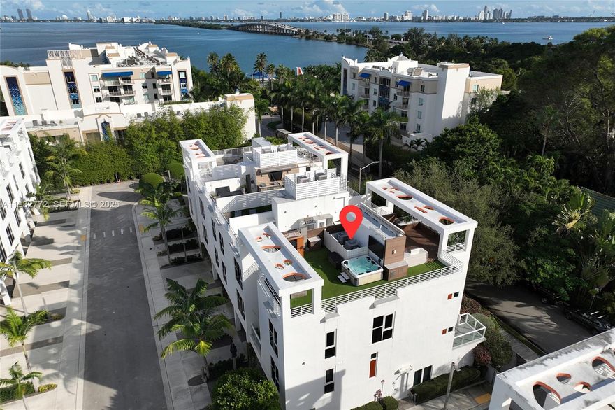 Incredible 4-story modern townhome at gated One Bay community in Miami’s coveted Design District! This 3-Bed/2.5-Bath contemporary residence offers privacy, community & an unbeatable location just minutes from the hottest shops, restaurants, parks & private schools. Up the stairs to the 2nd level, you’re greeted by the light-filled living area & kitchen complete w/ top-tier Bosch appliances, double height ceilings, fireplace & terrace. The 3rd level includes a media/family room, spacious primary suite + 2 guest bedrooms w/ a shared full bath.  4th level features an expansive private rooftop with full summer kitchen, lounging/dining areas, spa, sauna & views of the Edgewater skyline. The spacious garage even includes a Tesla car charging station! Direct access to Miami Beach causeway & I-95.