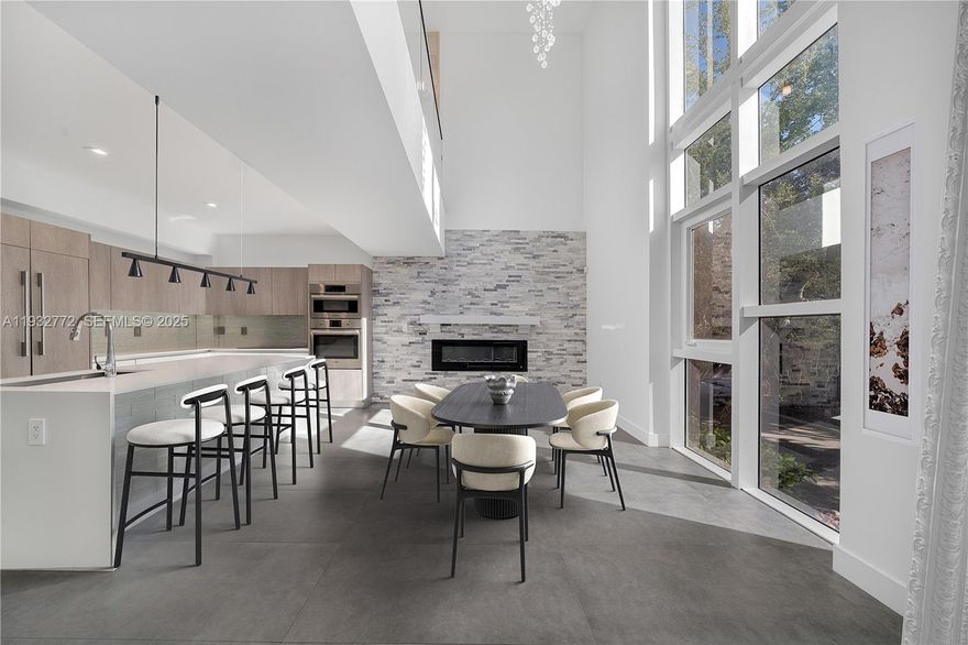 Incredible 4-story modern townhome at gated One Bay community in Miami’s coveted Design District! This 3-Bed/2.5-Bath contemporary residence offers privacy, community & an unbeatable location just minutes from the hottest shops, restaurants, parks & private schools. Up the stairs to the 2nd level, you’re greeted by the light-filled living area & kitchen complete w/ top-tier Bosch appliances, double height ceilings, fireplace & terrace. The 3rd level includes a media/family room, spacious primary suite + 2 guest bedrooms w/ a shared full bath.  4th level features an expansive private rooftop with full summer kitchen, lounging/dining areas, spa, sauna & views of the Edgewater skyline. The spacious garage even includes a Tesla car charging station! Direct access to Miami Beach causeway & I-95.