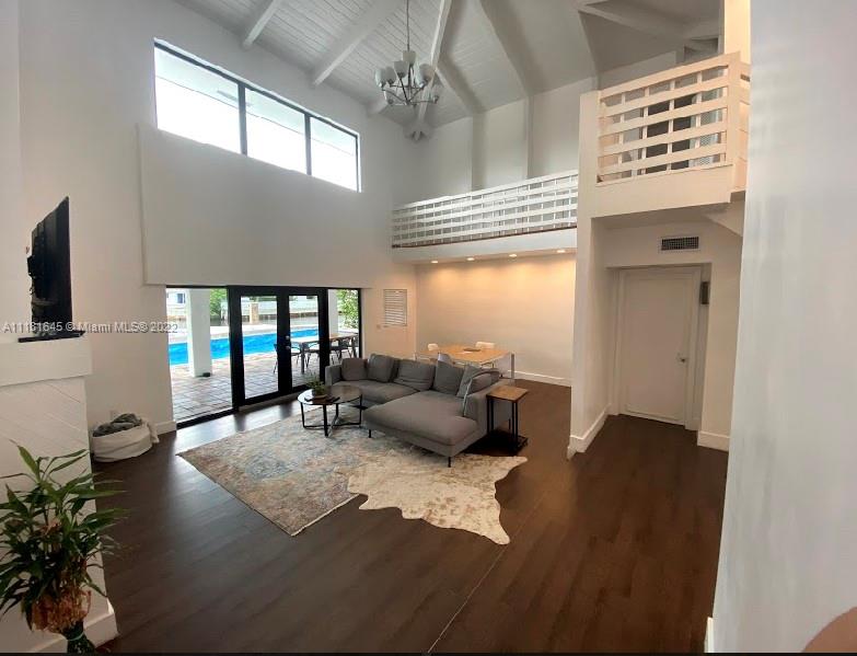 Beautiful 2 story waterfront home located in exclusive gated Eastern Shores. NEW sea wall and boat dock. High ceilings, Open floor plan and entertainment area overlooking the pool and intercostal water. Split loft style with 2/2 on the first floor and 2/1 on second floor, and a half bath that is accessible from the pool area. Custom eat-in kitchen, built -in stone oven & stove and laundry room. Spanish tile, wood floor in the bedrooms.