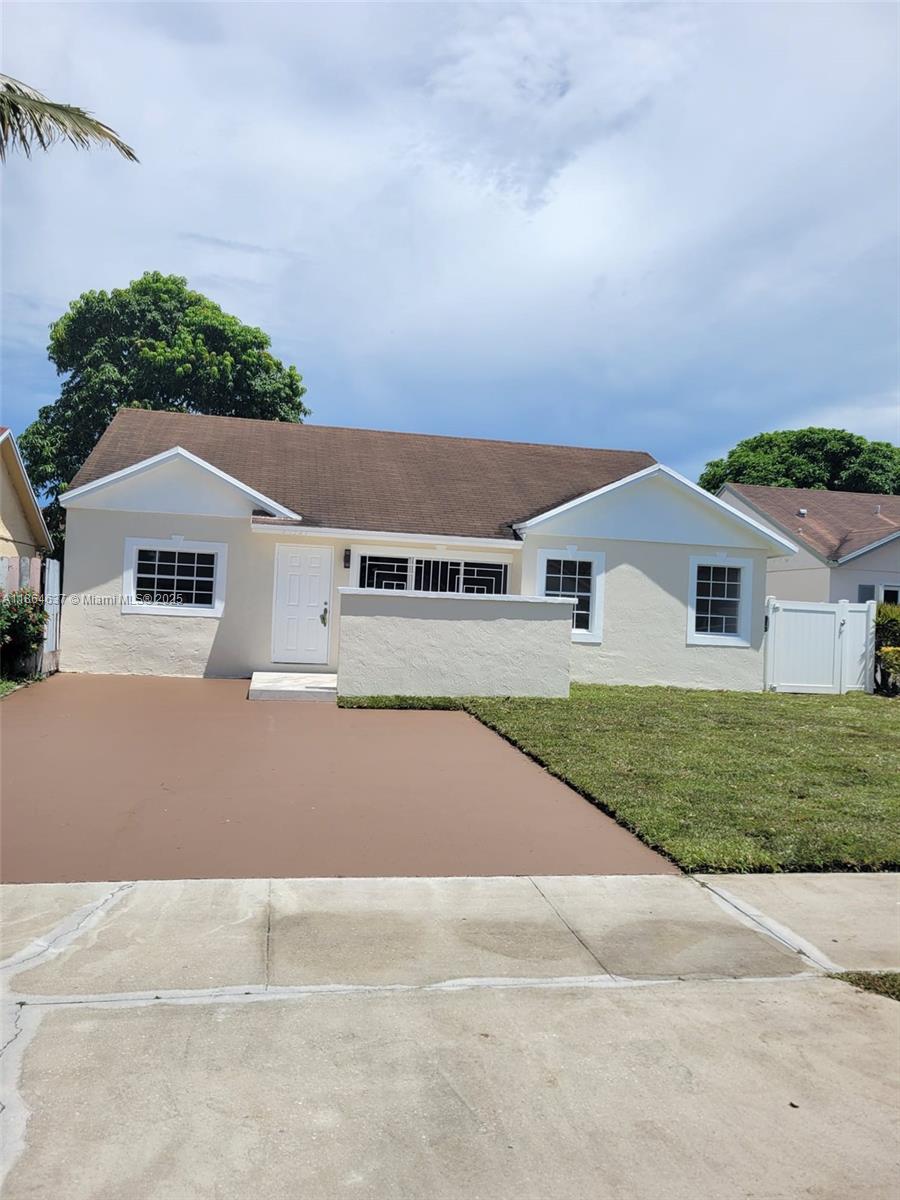 This property features a 1,400 square foot layout. It has been meticulously updated, including modernized plumbing and electrical systems and all-new flooring throughout the residence. The roof, installed in 2012, remains in excellent condition. The home boasts a newly renovated kitchen equipped with brand new appliances, as well as freshly painted interiors complemented by new interior doors and baseboards. Both bathrooms have been completely updated. Additional highlights include a spacious screened-in patio.
