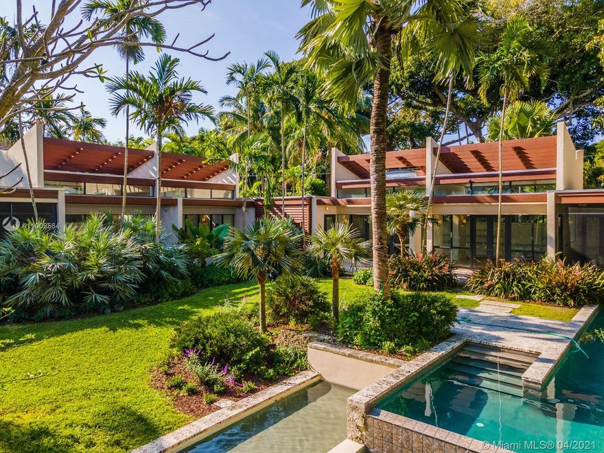 Welcome to your own paradise with a Masterpiece garden designed by Raymond Jungles. Spanning 19,500 SQFT with waterfall, lap pool, rock features and porches, it is the perfect tranquil retreat. Located on one of the most prominent streets in South Grove, this contemporary modern 2bed/3bath home designed by award winning architect Marc Turkel, AIA. Home was finished in 2003 and designed to be easily expanded to maximize room count and square footage without increasing the existing floor plate, making it perfectly modular to fit any taste and size household. Space, light and flow combines in perfect harmony. This is an opportunity not to be missed. Take a 10 min stroll to Grove village or 20 mins by car to Intl Airport. Tucked away but adjacent to A class schools and recreational activities.