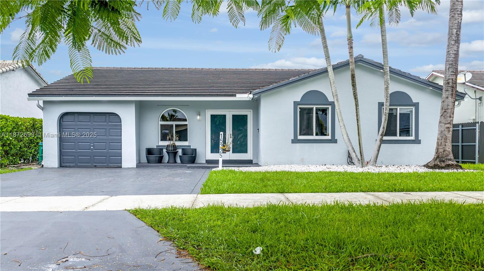 This beautifully updated home offers peace of mind and comfort with impact windows and doors, a brand-new AC (2025), and a recently installed roof. Inside, you’ll find tile flooring throughout and a custom kitchen with quartz countertops. The oversized covered back patio is perfect for entertaining year-round. Part of the garage has been converted into an additional bedroom, while still leaving space for storage.