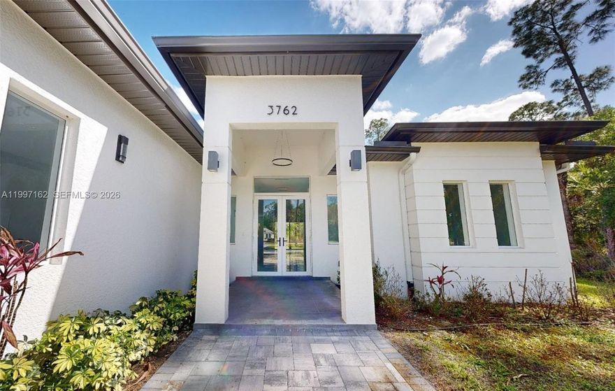 After the successful sell-out of five neighboring properties, 3762 32nd Ave SE is the last available from this developer in Golden Gate Estates, Naples, this home offers 4 bedrooms + den, 3 bathrooms + powder room on a 2.27-acre upland lot, providing space, privacy, and room to create your own oasis. The layout includes a spacious primary bedroom, one en-suite bedroom, two additional bedrooms with a shared bath, and a versatile den ideal for an office or flex space and a powder room for added guest convenience.
It also includes an elegant formal living area, a cozy family room, a functional laundry room, and a two-car garage with extra storage space.
The interiors stand out with high-end finishes, including impact windows, large-format 24x48 tiles, glass-enclosed showers, and modern cabinetry with a contemporary design and an EV charging station for today's lifestyle.
Outside, you’re welcomed by a paver driveway, a covered lanai connected to both the great room and the primary suite, ideal for outdoor gatherings, and an advanced reverse osmosis system for excellent water quality. 
The expansive lot allows you to design the pool, guest house, or recreational area you’ve always envisioned, combining understated luxury with total tranquility. With no HOA restrictions, this property is not only a home to enjoy today but also a solid investment for the future. Come see it and take the next step toward living in harmony with nature—without sacrificing comfort and elegance