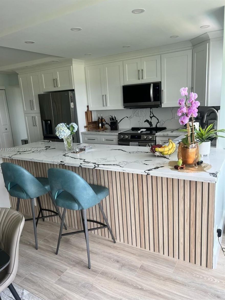 Beautifully renovated 2/2 condo with stunning views of the Coral Ridge Country Club golf course located one mile from Lauderdale-by-the-Sea beach. Move-in-ready featuring an
open layout, stylish flooring and natural light. Updated kitchen has contemporary cabinetry, luxury quartz waterfall countertops, upgraded LG appliances and washer/dryer.
Bathrooms are tastefully renovated with modern finishes. Tranquil views from golf course to Ft. Lauderdale skyline from your spacious living/dining area and primary suite with walk
in closet and en-suite bath.The second bedroom and full bath provides flexibility for guests or home office use. Enjoy peace of mind in a well-managed building with controlled
entry, covered parking, funded reserves, no pending assessments and all inspections passed