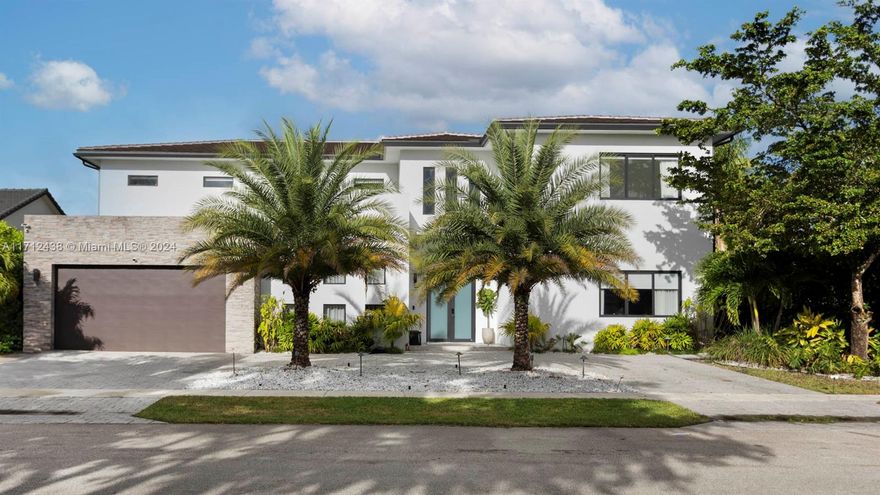 Featured on the hit Netflix series Designing Miami, this stunning 5-bedroom, 4.5-bathroom home with a theater room is a must-see. Newly built and completed in 2020, this sleek, ultramodern residence offers the perfect canvas for your personal style. Set on a prime waterfront lot, the property is surrounded by lush tropical landscaping and even includes a private putting green. Inside, you'll find custom finishes throughout, including Juliet balconies, 8-foot Italian doors, a double-sided wine cellar, and an expansive European-style kitchen designed for entertaining.