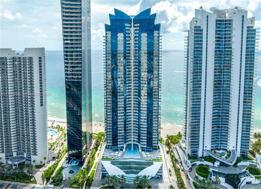 MAJOR PRICE IMPROVEMENT – NOW PRICED TO SELL.
Fully renovated corner residence on the 42nd floor at Jade Ocean, offering breathtaking panoramic ocean, Intracoastal, and city skyline views. This expansive 4-bedroom, 4.5-bath home spans 2,485 SF of refined interiors with floor-to-ceiling glass, quartz flooring, and white oak wood in the bedrooms.
Designed for modern luxury living, the residence features Smart Home technology, HD projector, automated shades, and a gourmet kitchen with premium appliances and custom cabinetry. The spa-inspired primary bathroom showcases elegant finishes and snap-glass details. Expansive terraces with river-rock flooring provide the perfect setting for sunrise and sunset views.
Recently repositioned, this is one of the best-priced fully renovated 4-bedroom residences in the building. Seller is motivated and ready to consider offers.
Enjoy five-star amenities including oceanfront pools, full-service spa, state-of-the-art fitness center, private cinema, and in-residence dining services. Prime Sunny Isles Beach location, close to world-class shopping and dining.
