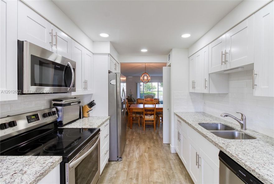 Beautifully renovated 2-bedroom, 2-bath, first-floor condo located in the highly sought-after Wynmoor community of Coconut Creek. Granite countertops, real wood cabinets, and stainless steel appliances highlight the modern kitchen, perfect for home chefs. Great layout with the dining room adjacent to the kitchen and a large family room that walks out to your private patio, overlooking the lake. The primary bedroom features a huge walk-in closet and en suite bath with designer finishes. WASHER AND DRYER IN UNIT! The second bedroom provides flexibility for guests or a home office. Wynmoor is a popular, gated, active 55+ community where residents enjoy resort-style amenities, including golf, pools, fitness center, clubhouse, tennis, and more—all in a beautifully maintained setting just minutes from shopping, dining, and major roadways. Inquire for a private showing.