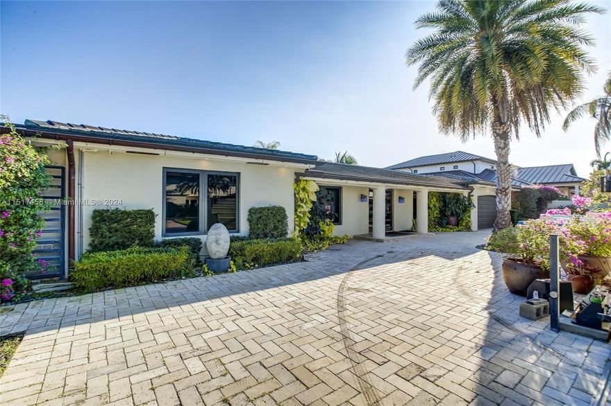 This amazing contemporary home built on 2 lots with large open design, allowing all glass doors to flow openly into the upscale pool and fully equipped outdoor barbecue/ bar area. The large "deep water" 107' dock is perfect for docking your boat or entertaining your friends. The 500 gallon underground gas tank supplies the heated pool with a perfect nighttime ambiance, surrounded by the beautiful lighted landscaping. The gourmet kitchen features upscale Stainless Steel appliances with a Wolf gas range. The kitchen layout is perfect for any intimate or large catered event. A very rare Brazilian tile flows throughout the home. A Miele coffee maker will start your mornings off with coffee. The large temperature controlled wine cellar will hold over 250 bottles of your favorite wines.