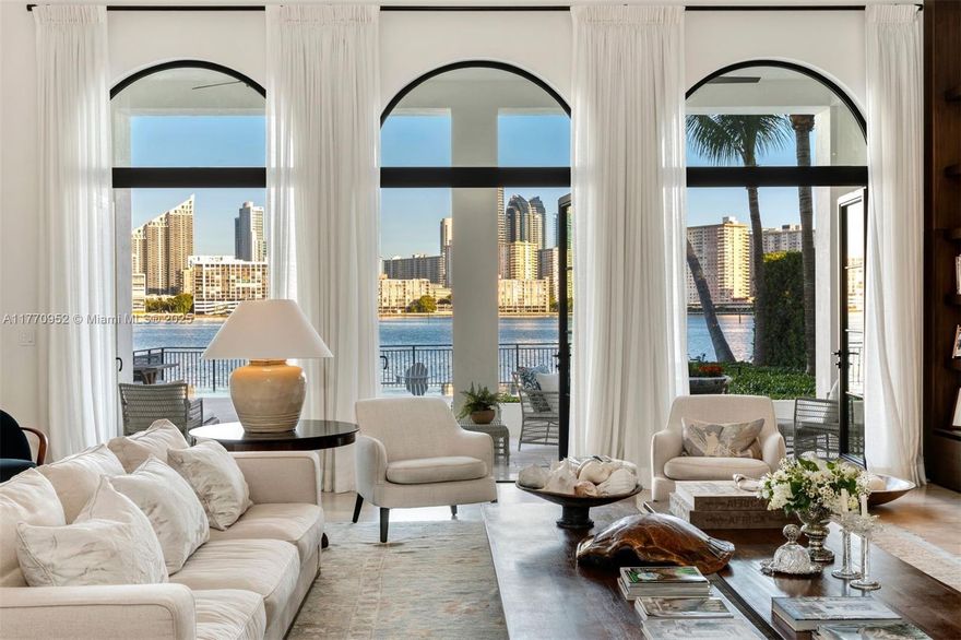 Step into waterfront luxury in Island Estates, Aventura’s exclusive gated enclave with just 22 homes. This architectural masterpiece offers breathtaking Intracoastal views, 40-ft ceilings, and a 110-ft private boat slip at the island’s premier marina. Designed for elegance and entertainment, this 4-bed, 4.5-bath estate features an open living space, a glass-enclosed wine cellar, and a chef’s kitchen with top-tier appliances. Private waterfront terraces offer a serene retreat, while the spa-inspired primary suite boasts a wet bar, walk-in closets, and a lavish ensuite. More than a home—it’s sophisticated, exclusive living.