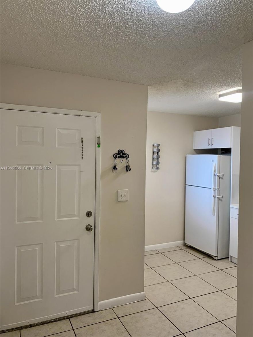 Great opportunity to own this renovated 3-bedroom, 2-bath corner unit located in the gated Villa Encantada community. This   unit features ceramic and laminate flooring, in-unit laundry, and updated finishes. Recent upgrades include a new roof (2025) and new A/C unit (2025). The community is well maintained and investor friendly with no rental restrictions. Property is currently rented.