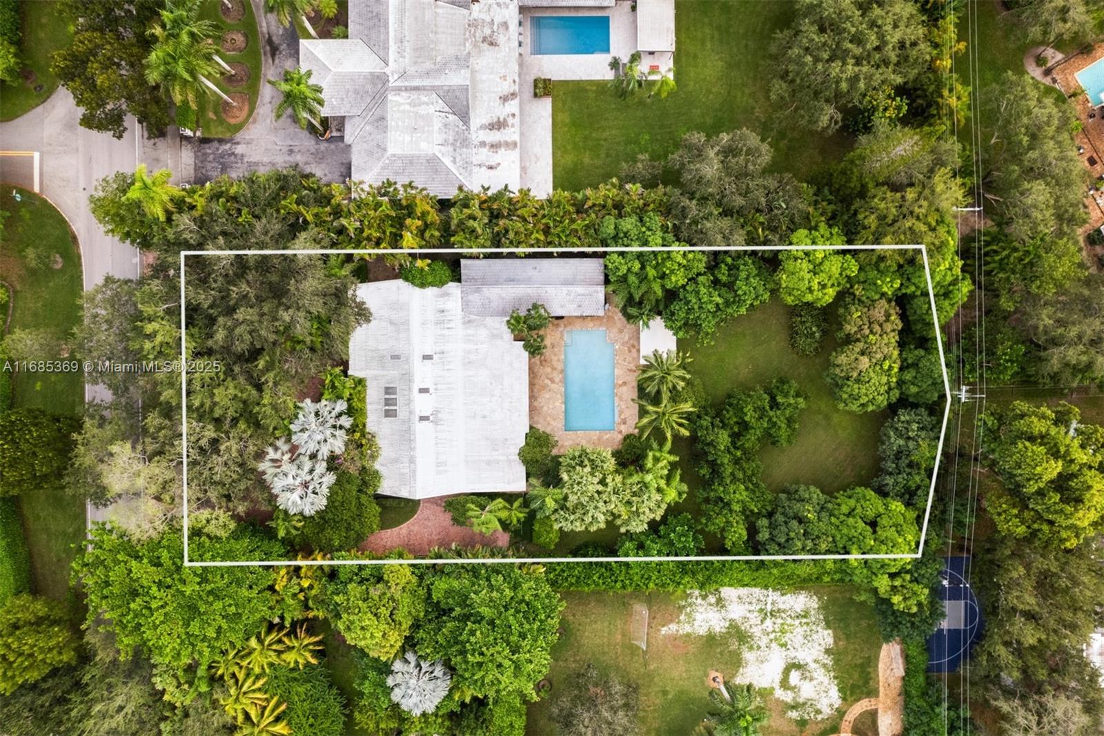 Explore the possibilities: live, renovate, or create your dream estate on this distinguished property in Pinecrest. Covering 38,768 sq. ft., this lot offers endless potential for custom construction or enhancing the charm of the current home. Inside, a gourmet kitchen with a cozy breakfast nook flows effortlessly into a flexible area ideal as a family room or home office. Outside, enjoy your own private retreat with a covered terrace, spacious pool, and beautifully landscaped yard surrounded by mature trees. Additional features include impact-resistant windows and doors and a roomy 2-car garage. Move-in ready and situated in Pinecrest, renowned for its luxury homes, top schools, and proximity to dining, shopping, and parks—this location is truly exceptional.