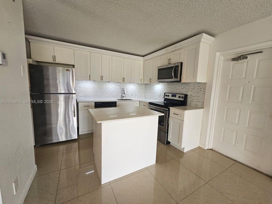 Beautifully renovated unit. Features include a modern kitchen with new stainless steel appliances, new tile flooring, in-unit washer/dryer, and a screened balcony overlooking the lake. Located in a gated community with resort-style amenities including a pool, tennis and racquetball courts, walking trails, and community room. Move-in ready and designed for easy living.
