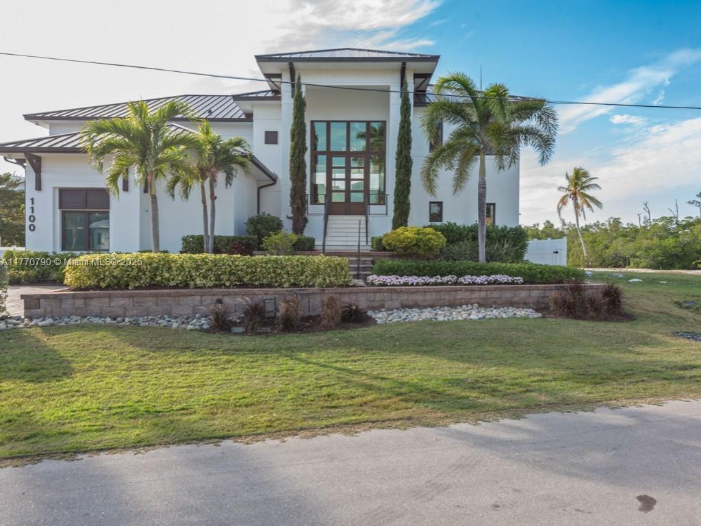 Spacious 4 BR. Plus home. Built in 2021. Waterfront home with Western exposure. Quick out to Naples Bay. One mile to Downtown Naples. Water views & pool views from every room. Elegant entry with soaring 17ft. ceiling all glass. Elevator, linear fireplace, pantry, 2 kitchens, Great room design with coffered ceilings. 12 & 10 ft. ceilings throughout. Two master suites. Covered patio & pool deck 1900 sq.ft. with gas heated pool & 8-man spa with fire pit. Dock 70 ft. in length 1100 sq ft. with lift for boat. Family room 556 sq.ft. possible in-law suite, home gym or 5th BR. Outdoor summer kitchen. 2–5 ton A/C, generator, 3 car garage. Electric storm shutters. Impact glass. Fenced in yard. Home being sold below appraised value. NO WATER IN HOME OR ON POOL DECK DURING IAN.