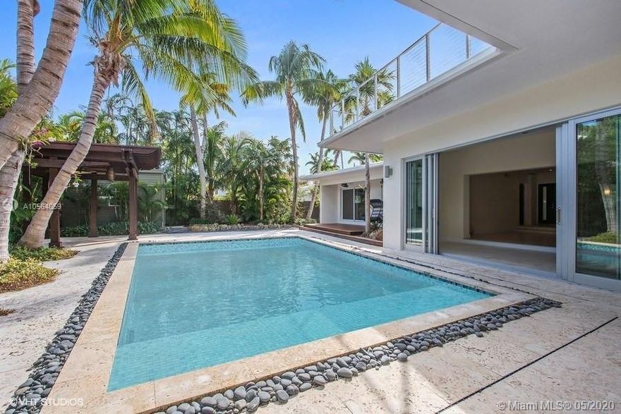 LIVE VIRTUAL TOUR-Call to schedule now- Enjoy your own tropical oasis in the coveted Holiday Colony in Key Biscayne.  Perfectly located steps from sandy white beaches nestled on a lush 12,246sf lot.  A beautiful, tree trimmed circular driveway welcomes you to this spacious and light-filled home.  The foyer entryway opens to a large open space with views of the stunning outdoors.  Tall sliding glass doors lead you to a backyard featuring a saltwater pool, gazebo, Ipe wood deck, and large entertainment areas.  Upstairs media room and office with architecturally designed windows, wrap-around balcony, and outside entertainment area. Boasting 4 bedrooms and 4 and 1 half bath.  Formal dining, newly remodeled kitchen, and family room.  Rich oak hardwood floors and marble flooring.