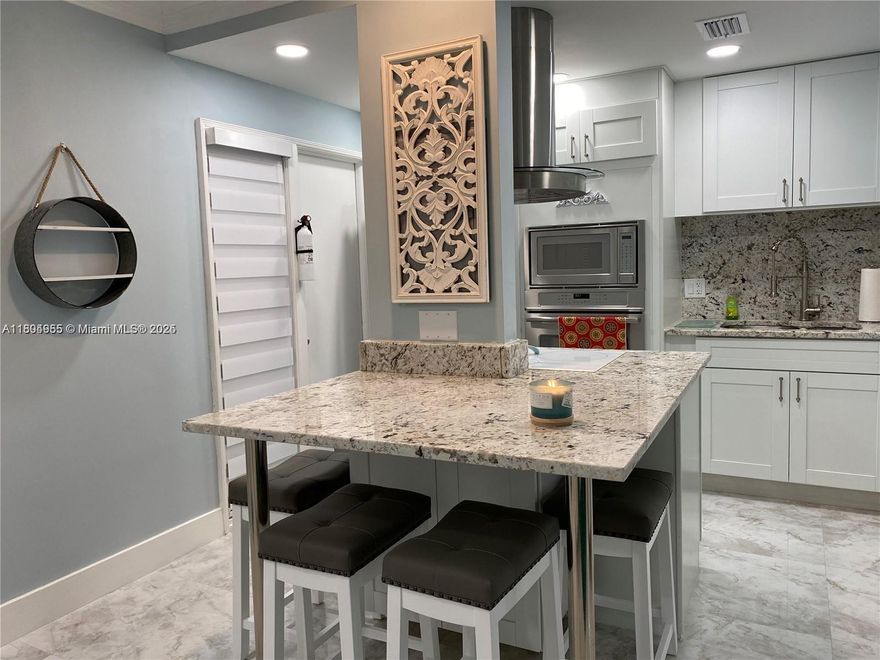 Luxurious Beach Getaway... Fully furnished & remodeled, this unit evokes a sense of COZY-RELAXATION in a tropical paradise. Walking in, the floor plan opens to the living and kitchen area with modern and upscale décor and furnishings. Kitchen is outfitted with SS appliances, granite counter-tops, shaker style cabinets, and stocked with dishware, silverware, cookware.... Porcelain floors flow throughout the flat in all rooms. Relax by the heated pool or take a short walk to the beach; as public access is very near. Also, a short walk to local dining, shopping and parks. The unit includes 1 assigned parking space, guest parking and laundry facility within the building. --NO BALCONY in UNIT-- SHORT TERM RENTALS ADD $200 a month and ADD TAX,