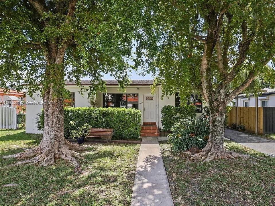 This charming and spacious 3-bedroom, 2-bath mid-century home offers vintage character and modern comforts in a prime location. Featuring beautiful hardwood oak floors in the main living areas and stunning terrazzo floors with wood beam ceilings in the Florida room, this home blends classic charm with unique design touches. Enjoy a remodeled kitchen, a flexible split-bedroom layout, and a large utility room—perfect as extra storage, a workshop, or even an art studio. The expansive yard offers ample space for outdoor entertaining or relaxation. Located just minutes from Coral Gables, the vibrant Calle Ocho District, and Downtown Miami. Zoned for Gables Middle and High School. Has E/V Tesla charger.