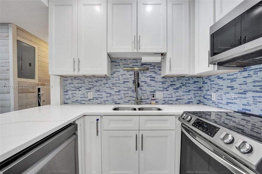 BIKE TO THE BEACH!! WALK TO CORAL RIDGE COUNTRY CLUB!! YOU CAN RENT RUGHT AWAY! You can rent this right away! NO SHORT-TERM RENTAL RESTRICTIONS WITH HOA APPROVAL.  This 2 bed/2 bath property has been completely remodeled in a coastal/contemporary fashion.  A corner unit provides extra natural light with a private side yard for grilling & entertaining. Take advantage of a turnkey, 2 story property w/a pool only shared by a few units. 2 DEEDED PARKING SPOTS + GUEST SPOTS- Enjoy living out East (UNDER 400K!) where you are minutes from the beach, golf courses, Lauderdale by the Sea, the pier, all kinds of shopping & eateries. All impact windows & doors, newer appliances, washer/dryer in the unit, you may rent if you wish. LOW HOA! Extra exterior storage/shed. Huge side PRIVATE yard!