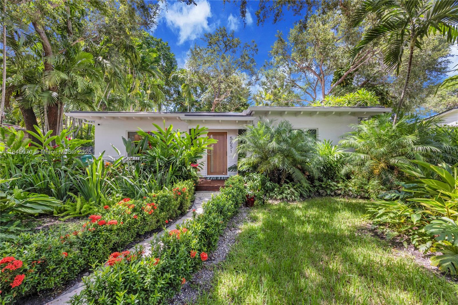 Your mid-century modern dream home awaits! Stunning architecture featuring open great room with clean lines and open beamed ceilings. Kitchen features a large center island that seats 8+ diners. Double French doors and floor to ceiling windows along the back wall of the great room creates a seamless indoor-outdoor living space. Expansive windows bring the outdoors in and allows beautiful natural light into the home. Fabulous curb appeal w/luscious tropicals and mature oaks & lovey mid- mod style front impact door and lighting. Dreamy backyard boasts poured concrete patio, artificial turf, and covered entertaining area. Located in coveted Biltmore Heights, renowned for friendly community vibe and walkable, pet-friendly streets. Impact windows and doors, great parking, fenced back yard.