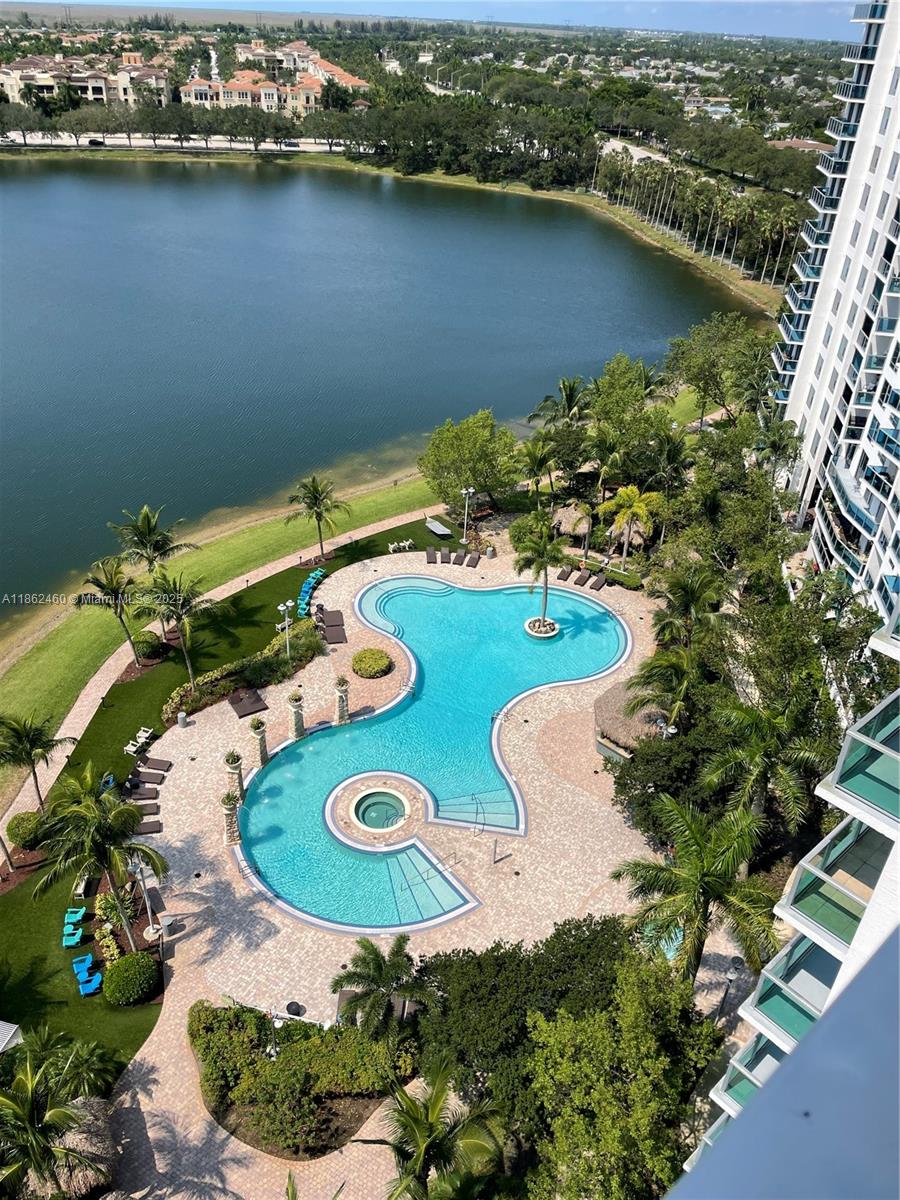 This spectacular and immaculate 2-bedroom, 2-bathroom apartment offers an amazing view of the lake and is located in the highly desirable Tao Sawgrass community. The unit features an open-concept layout with floor-to-ceiling windows, and a modern kitchen equipped with granite countertops and stainless steel appliances. The master suite includes a walk-in closet and a spa-like bathroom with a separate tub and shower. Additional amenities include a washer and dryer, as well as two parking spaces. Residents can enjoy resort-style amenities such as a fitness center, swimming pool, sauna, tennis courts, playground, putting green, BBQ area, and 24-hour security. Conveniently situated across the street from Sawgrass Mills, the apartment is also close to various restaurants and major highways.