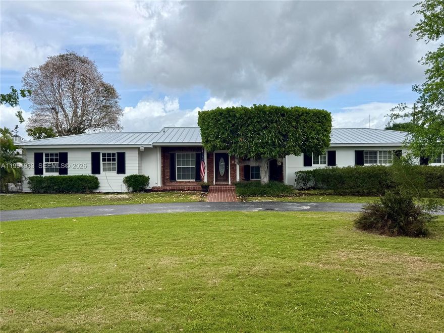 BEAUTIFULLY LOCATED HOME ON 2+ ACRES IN THE REDLAND.  4 BEDS 2 BATH WITH EXTRA ROOM ATTACHED TO SCREENED PATIO.  FULLY AIR CONDITIONED DETACHED 3 CAR GARAGE/WORKSHOP.  ATTACHED GARAGE FOR ADDITIONAL CAR AS WELL!  LARGE POOL WITH SCREEN ENCLOSURE MAKES FOR A LOVELY ENTERTAINMENT AREA. SPACE FOR A HORSE OR TWO! FULLY FENCED BACK YARD. LOVELY LANDSCAPING. NO HOA!!!