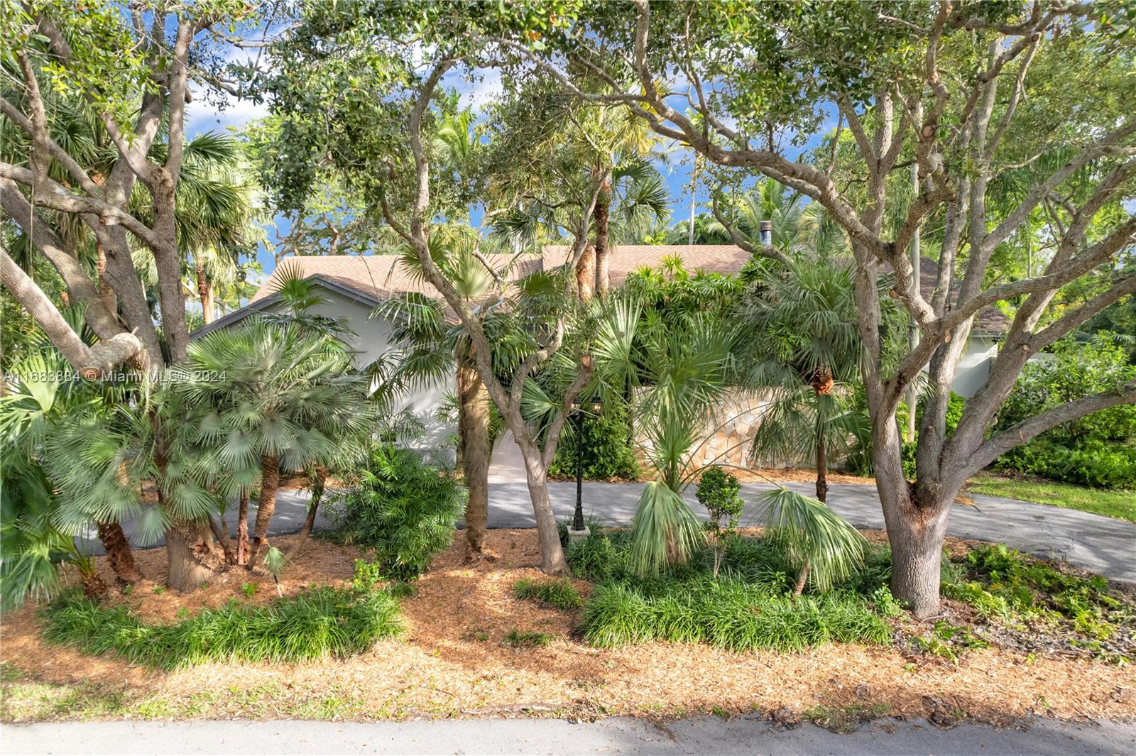 This remodeled Palmetto Bay residence combines elegance with modern upgrades on a tranquil, tree-lined street. Surrounded by lush tropical landscaping, the home welcomes you with a double-door entry and a bright foyer overlooking a landscaped atrium. Volume ceilings create spaciousness, while the kitchen and family room showcase rich wood accents and a striking river rock fireplace. The split bedroom plan provides privacy, featuring a remodeled master suite with a stunning new bathroom and brand-new appliances. Enjoy the poolside views from the breakfast nook, or relax on the spacious covered patio enveloped by greenery. A circular driveway and side entry to a two-car garage complete this charming oasis. Renters insurance required for duration of lease