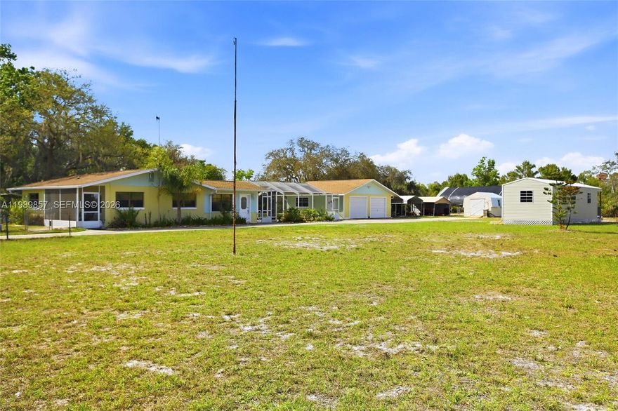 Set on an impressive 4.18 acres in Lake Placid, this 2-bedroom, 2-bath home with a 1/1 mobile home offers a total of 3 bedrooms and 3 bathrooms.  This property provides space, privacy, and endless potential—backing up to a peaceful sanctuary for added tranquility and natural views.
Inside, you’ll find a spacious floor plan with tile flooring throughout, creating a clean, low-maintenance living environment. The layout offers comfortable living and dining areas, ideal for both everyday living and entertaining.

Step outside to your enclosed pool—perfect for year-round enjoyment in a private setting.

The property features a double attached garage with ample space for vehicles, storage, or a workshop. An auxiliary suite adds incredible flexibility, offering the potential to be completed into a separate living space for guests, extended family, or even rental income.

Partially fenced with a storage shed already in place, the land provides plenty of room to expand, garden, or simply enjoy the quiet surroundings.

A rare opportunity to own acreage with versatility, privacy, and room to grow.