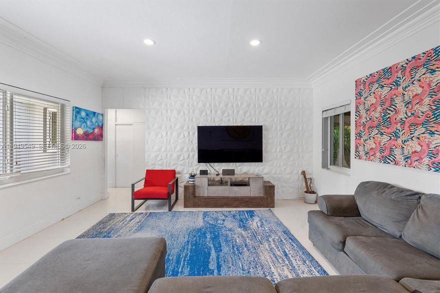 An exceptional opportunity to own a true waterfront gem in North Miami, where comfort, flexibility, and future upside converge. This beautifully updated 3-bedroom, 2-bath residence is positioned on an oversized lot along the Biscayne Canal, offering approximately 1,950 square feet of thoughtfully designed living space plus a rare 700 square foot detached garage/studio located directly on the water—ideal for a home office, gym, guest suite, creative studio, or additional entertaining space. The open and inviting kitchen is designed for both everyday living and hosting, featuring granite countertops, stainless steel appliances, generous cabinetry, and seamless flow into the main living areas. White tile floors and impact windows throughout enhance the bright, airy feel while providing peace of mind. A spacious primary suite anchors the desirable split-bedroom layout, offering privacy and comfort. The large screened porch overlooks lush native landscaping and mature fruit trees, creating a tranquil outdoor setting perfect for morning coffee or evening gatherings. Natural gas line in place. Enjoy serene canal-front living today, with the added long-term value of planned direct access to Biscayne Bay by 2030—an exciting opportunity for boating enthusiasts and future-minded buyers alike.