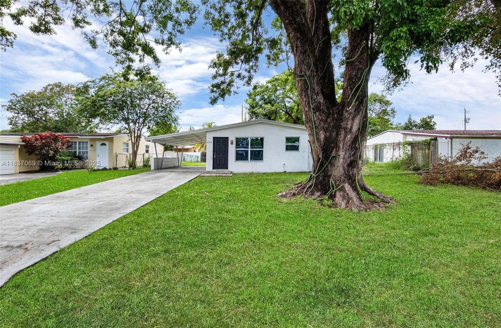 Move-in ready ranch style home featuring a 3/2 layout, a covered carport, and plenty of backyard space. The interior includes recent kitchen updates, offering a modern touch while maintaining a comfortable layout. Ideal for buyers seeking a well-maintained home with room to relax or entertain outdoors.