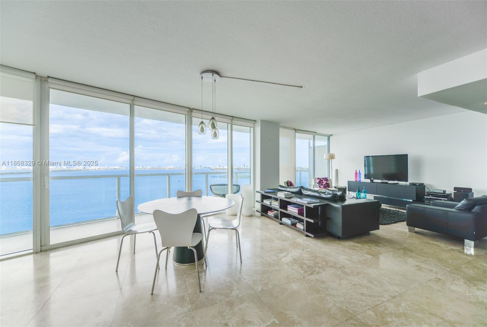 This is the best water view unit in the building! Start your mornings with positive energy in this fully furnished, spotless, and move-in ready home. Currently converted into a 1-bedroom, it offers a spacious living and dining room and can easily be converted back into a 2-bedroom. Located on a high floor, the unit boasts breathtaking water views and is within walking distance of the Design District, Publix, pharmacies, and more. It features a large balcony, floor-to-ceiling windows in both the bedroom and living room, and marble floors.