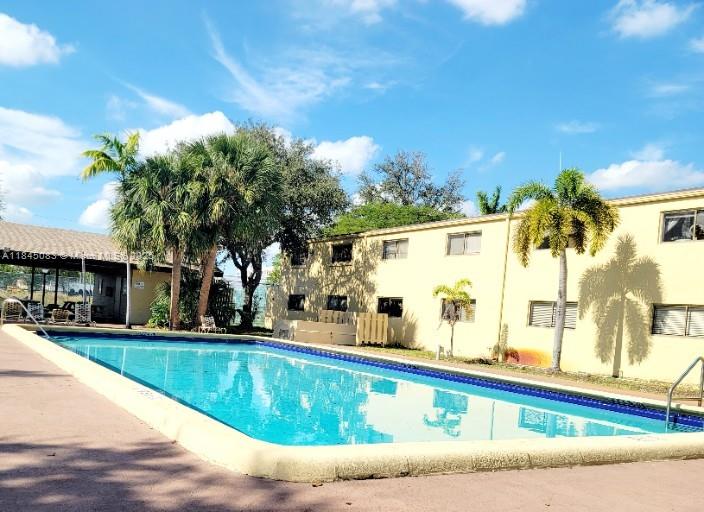 Spacious 2/2 First-Floor Corner Unit featuring a private screened porch entry and parking right at your doorstep. The unit is well-maintained and currently rented through August 31, 2026 for $1850, generating immediate rental income. It offers tile flooring throughout, a long L-shaped kitchen counter that opens to the living room, in-unit laundry with a washer and dryer included—perfect for everyday living or entertaining. Enjoy walk-in closets, extra storage, and a gated pool with a cabana area just steps away. Prime location—walk to parks, shopping, schools, and entertainment, and just minutes from the beach. A great opportunity for investors seeking steady cash flow!