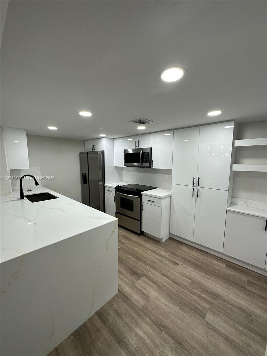 Completely remodeled 2/2 in The Greens at Doral, the largest model available with high ceilings and a private upstairs master suite. Features include a new kitchen with quartz countertops, stainless steel appliances, and a wine refrigerator. Enjoy stunning views of the lake and Trump National Golf Course. Gated community with pools, clubhouse, gym, and tennis courts. Walking distance to Starbucks, Publix, Shoma Bazaar, and top restaurants.