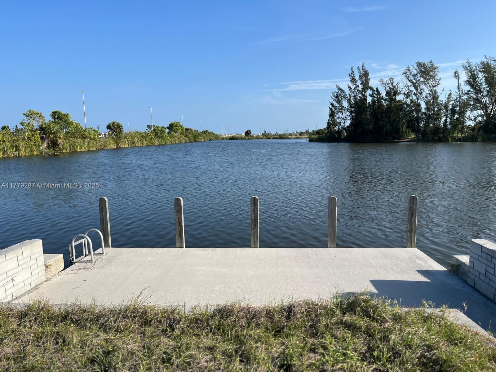Exceptional opportunity to own a prime corner lot with water access, featuring a newly constructed seawall and a solid concrete dock. This oversized lot is perfectly situated in a highly desirable area—just minutes from top-rated markets, beautiful beaches, and renowned fishing spots. Ideal for building your dream waterfront home or as a solid investment in a rapidly growing location. Don’t miss the chance to secure this rare and valuable piece of property!