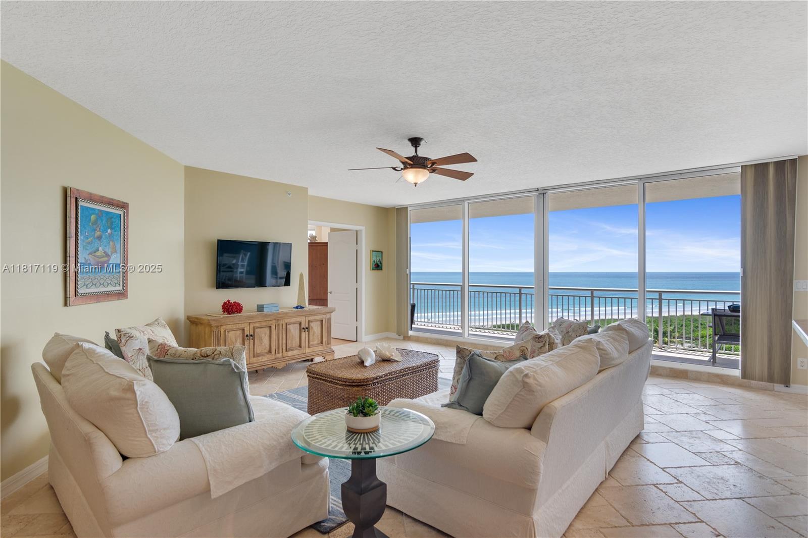 This private 3-bedroom coastal retreat on the seventh floor of the prestigious Atrium building, offers stunning panoramic ocean views. Enjoy a bright, open layout with floor-to-ceiling windows, soaring ceilings, and a kitchen featuring stainless steel appliances that flows into the living area. The split-bedroom floor plan provides privacy and comfort. The primary suite offers sweeping ocean views, two walk-in closets, and an en suite bathroom. The main living areas feature travertine stone flooring, for beauty and easy maintenance. Resort-style amenities offer direct beach access, a clubhouse with full kitchen, billiard room, library, media room, fitness center, heated pool with hot tub, sauna, tennis and pickleball courts, bike room, car washing station, and a secure gated community.