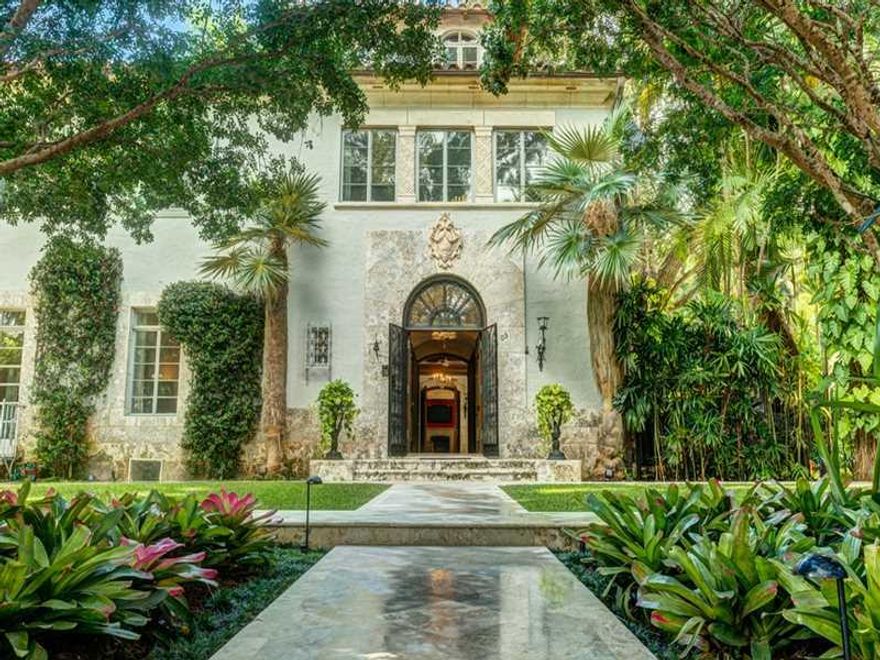 Designed by Phineas Paist on an enchanting Raymond Jungles landscaped Double Lot, this legendary estate from the 30's offers the romance of a bygone era while seamlessly updated & expanded; from the lavish sauna, cabana bath & gym flanking the 76' lap poo l to the media room, studio, large office & guest suites,no luxury is overlooked. Quarried limestone walls; inlaid marble floors; high ceilings, impact windows, Otis elevator, gracious courtyard,3 fireplaces, motor court & all balconied ensuite bedrooms.