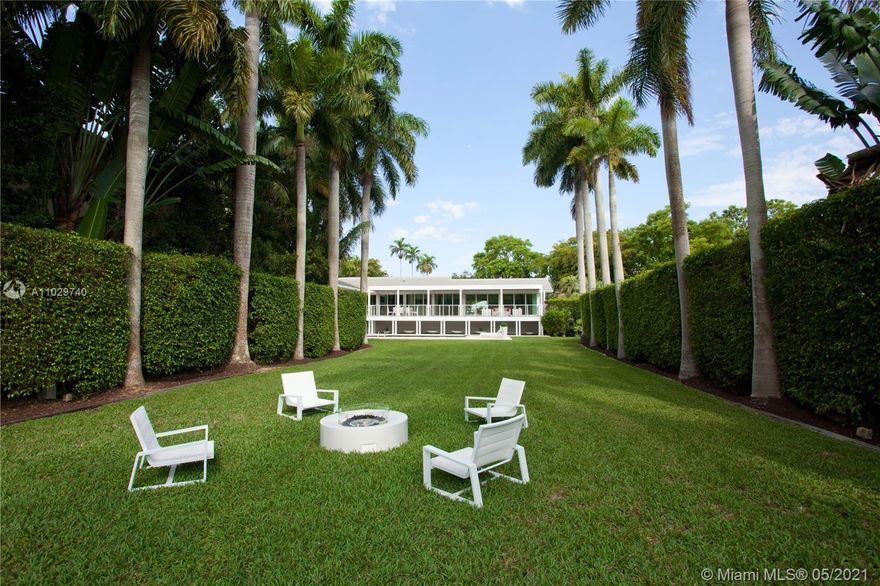 Unique Waterfront Contemporary Home in Gated Exclusive Cocoplum. This home w/new roof & impact windows & doors was recently remodeled. It features a bright & open floor plan. The large living & dining rm w/bamboo floors overlooks the beautiful backyard & pool area through a complete glass wall. Large open terrace to enjoy the view of the back yard lined by Royal Palms, leading to the dock & waterway. The modern kitchen opens to the spacious family rm. 5 bedrms, 6/1 bathrms. A large main suite w/a walk-in closet & balcony overlooking the backyard. 2-car garage, cabana bath & open bar area by the pool. Large bonus area downstairs for storage. Waterfront with 50 feet dock and seawall. This residence sits on a gated corner lot for maximum privacy with direct access to Biscayne Bay.