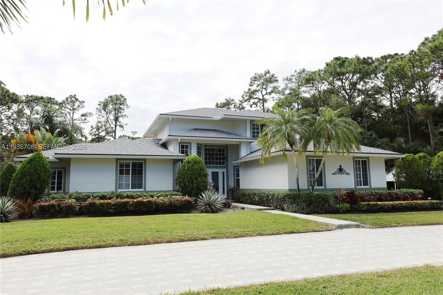Loan qualified for assumption at 4.875% for qualifying buyer. Live in a secluded oasis just minutes from everything: Alton, Abacoa, I-95, Tpk. This 4-bed, 2.5-bath home is filled with glass that makes living flow out onto decks, a tropical, resort-style pool and spa and 1.16 acres of manicured yard. Owner has put $250K in upgrades in the last three years: automated Lutron lights throughout, porcelain tile, renovated kitchen, interior knockdown walls/ceilings, new heater/pump for salt pool and spa, security cams, new doors and moldings, new: back patio Sonos speakers, whole house ion exchange water filter, well irrigation pump with 8-zones, lanai mister, water heaters, lanai awnings, fiber optic, custom master closets. Designed to live indoors and outdoors with every amenity to make memories inside and out. Oversized master suite with double closets, sitting area and deck overlooking the pool. Two outbuildings for yard and toy storage. Detached carport on side for additional vehicles or boat. Multiple rooms are flex: office can be formal dining, 4th bedroom can be office, second dining can be den. You have to see this home to fully appreciate the extensive renovations performed to accommodate comfort and outdoor living.